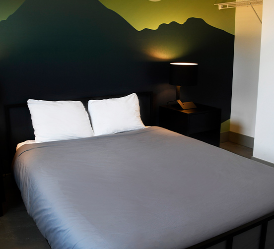 Bed with mountain silhouette on headboard wall