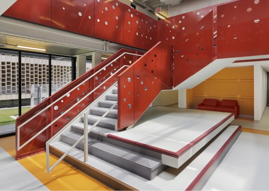  A red-walled staircase in a modular facility